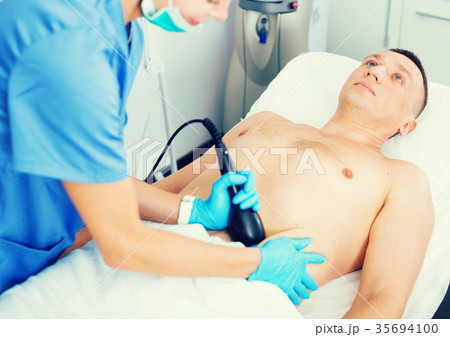 Female doctor is doing vacuum massage procedure for anti-fat to patient 35694100