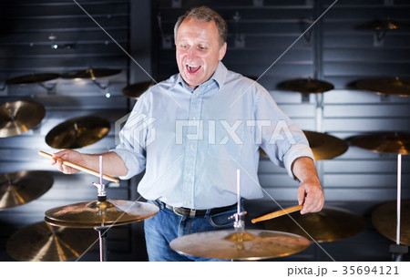 Musician playing on drum kit Musician playing on drum kit 35694121