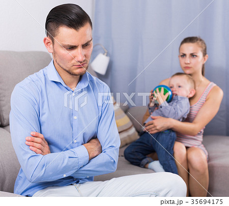 Sad male and female with child thinking about quarrel 35694175