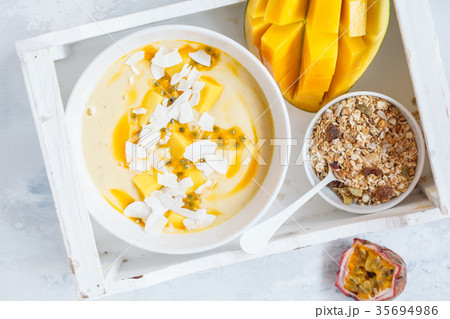 Mango smoothie bowl with coconut, granola Mango smoothie bowl with coconut, granola 35694986