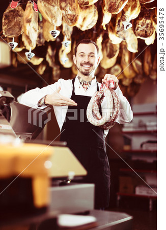 Seller weighing sausage Seller weighing sausage 35695478