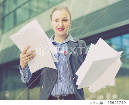 Employee glad woman standing with paper documents 35695739