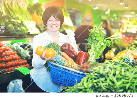 Adult female taking fruits with basket 35696075