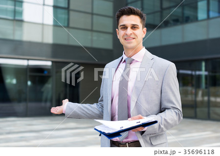 Businessman in welcoming gesture Businessman in welcoming gesture 35696118