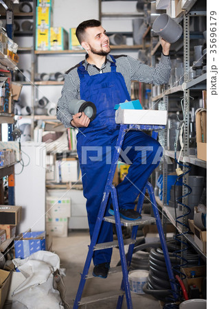 Worker selects the details of the sewer pipes Worker selects the details of the sewer pipes 35696179