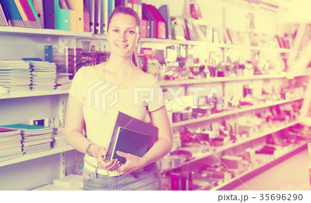 Positive woman buying products in stationery shop 35696290