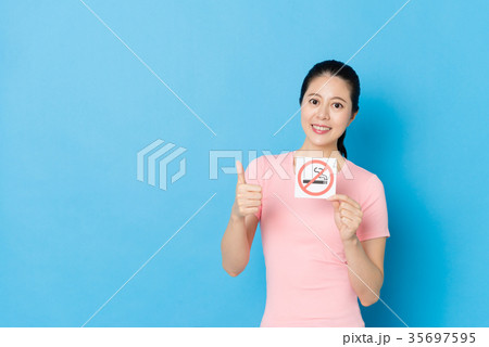 confident young girl holding quit smoking symbol confident young girl holding quit smoking symbol 35697595
