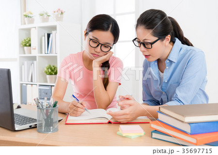 attractive college student girl doing homework attractive college student girl doing homework 35697715