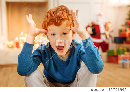 Amazed ginger child cannot believe his eyes Amazed ginger child cannot believe his eyes 35701945