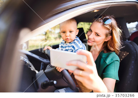 Young mother with smartphone and baby boy in the 35703266