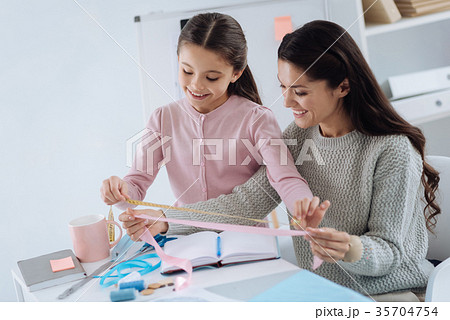 Happy cute girl holding a tape measure 35704754