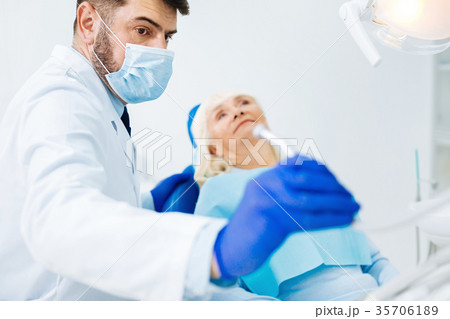Close up of professional dentist with instrument 35706189