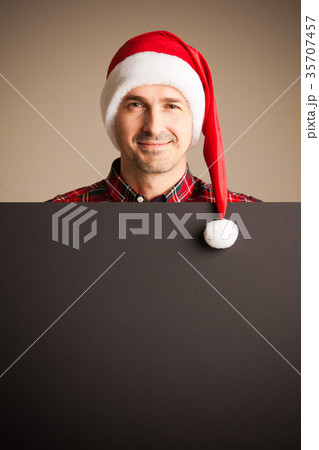Man in santa christmas hat holding placard 35707457