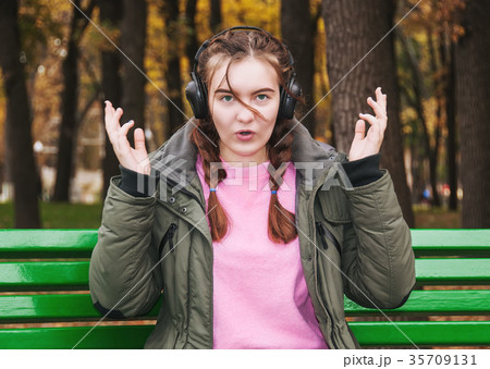 Surprised young girl with headphones 35709131