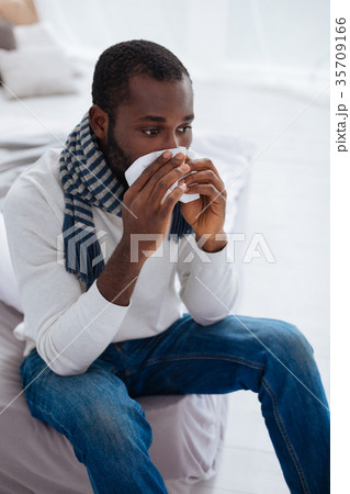 Unlucky young man staying at home and being ill Unlucky young man staying at home and being ill 35709166