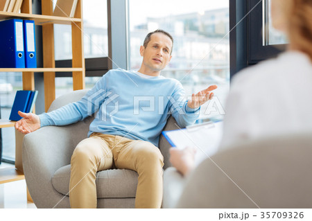 Nice handsome man talking to his doctor Nice handsome man talking to his doctor 35709326