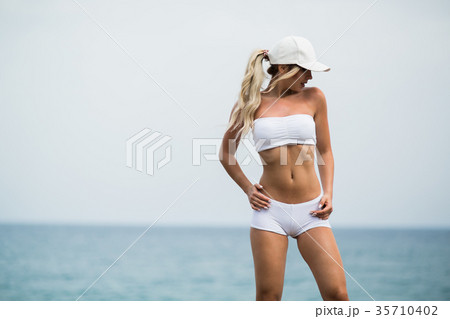 Fitness girl with a perfect body is smiling near 35710402