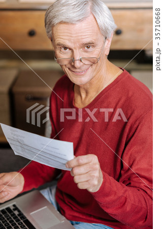 Joyful nice man working at the laptop 35710668