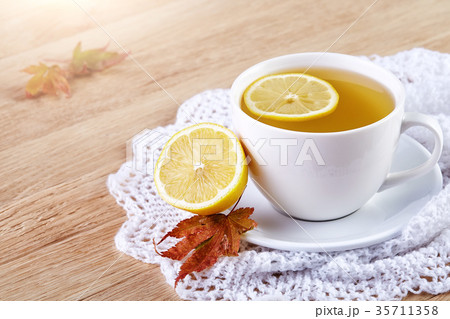 Tea with lemon in white cup, cinnamon sticks 35711358