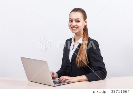 Picture of beautiful business lady working on PC 35711664