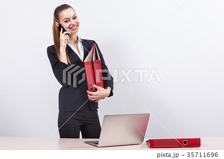 Picture of beautiful business lady talking a phone Picture of beautiful business lady talking a phone 35711696
