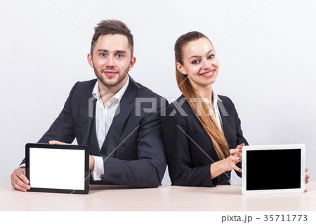 Picture of couple of office workers both holding 35711773