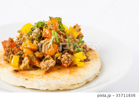 Colombian arepa topped with ground beef 35711836
