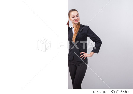 girl in a business suit stands next to the board 35712365
