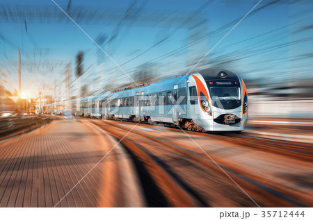 High speed train arrives on the railway station High speed train arrives on the railway station 35712444