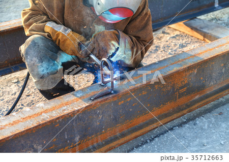 Worker welding in a factory.  35712663