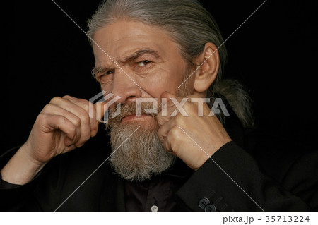 Strict look of very old beardy man. 35713224