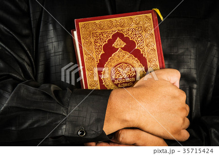 Koran in hand ,Quran in hand - holy book of Muslim Koran in hand ,Quran in hand - holy book of Muslim 35715424