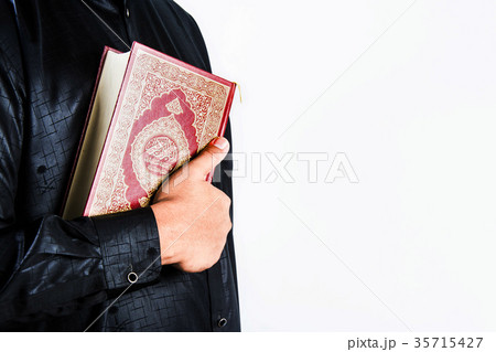 Koran in hand ,Quran in hand - holy book of Muslim Koran in hand ,Quran in hand - holy book of Muslim 35715427