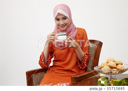 malay girl with tudung holding cup of hot tea 35715695