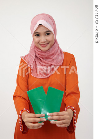 malay girl with tudung with green envelope 35715709