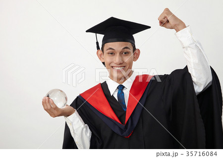 graduated student holding glass globe 35716084