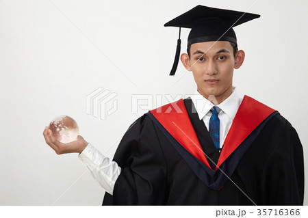graduated student holding glass globe 35716366