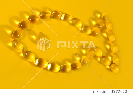 Omega-3 fish fat oil capsules shaped in fish Omega-3 fish fat oil capsules shaped in fish 35726289