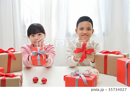 Happy Asian boy and girl holding a gift boxes. 35734027