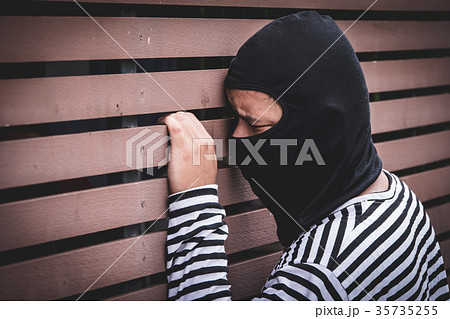 Robber hiding behind the wall Robber hiding behind the wall 35735255