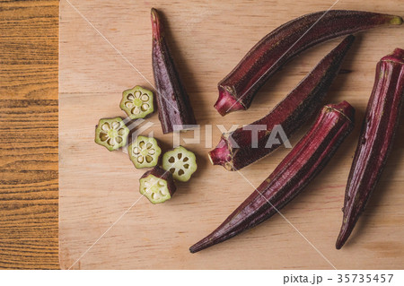 Fresh Red okra on wooden background. 35735457