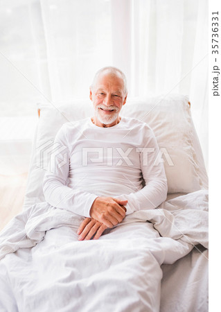 Senior man lying in bed at home. 35736331