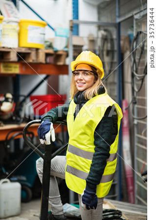 Young female worker in a warehouse. Young female worker in a warehouse. 35736444