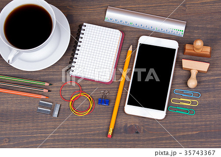 Top view of Cup of coffee with smart phone on wooden background 35743367