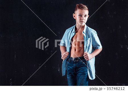 Boy in shirt posing for camera 35746212