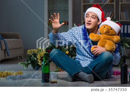 Man celebrating christmas at home alone 35747350