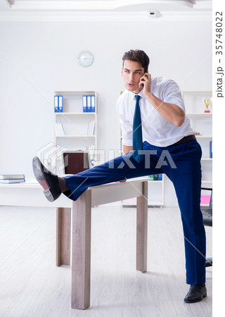 Young businessman doing sports stretching at Young businessman doing sports stretching at 35748022
