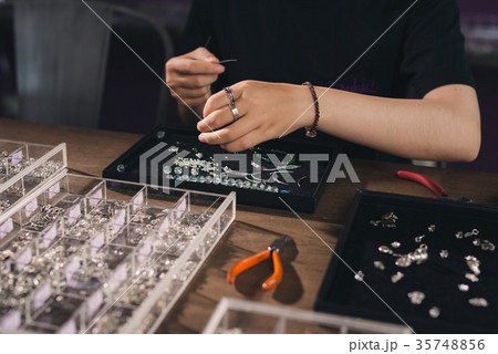 Female designer making jewelries at a jewelry shop Female designer making jewelries at a jewelry shop 35748856