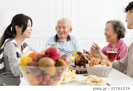 Happy family having dinner together. Happy family having dinner together. 35761374