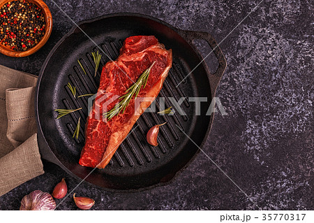 Beef steak on a dark background. 35770317